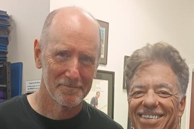 Clark and McElroy posed standing, smiling.