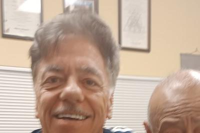 McElroy and Inosanto posed standing, smiling, arm on shoulder.