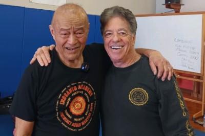 Guru Inosanto and Sifu McElroy posed standing with arms around shoulders